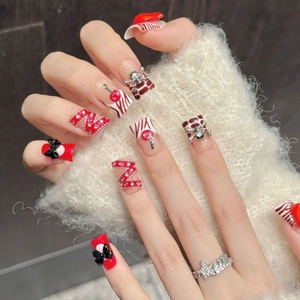 Red cherry and bow handmade press-on nails with silver skull charms and star ring