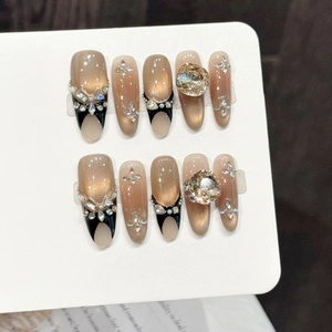 Handmade brown cat-eye press-on nails with blue-pink gradient, rhinestones, and French tips
