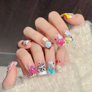 3D handmade press-on nails featuring floral and butterfly designs on clear tips