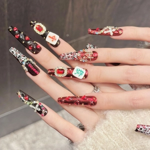 Handmade mahjong press-on nails with red and black crystals in long coffin shape