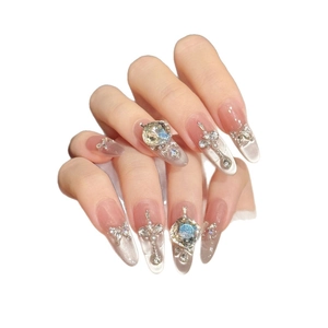 Handmade nude press-on nails with silver cat-eye effect and 3D crystal butterfly charms