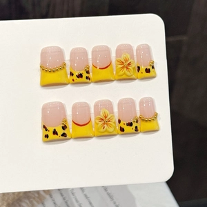 Handmade yellow cherry blossom press-on nails with 3D floral accents and golden beads