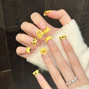 Yellow press-on nails with 3D cherry blossoms, leopard prints and pearl bead accents