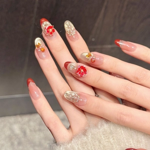 Elegant red and champagne gold gradient press-on nails with 3D flowers and crystals