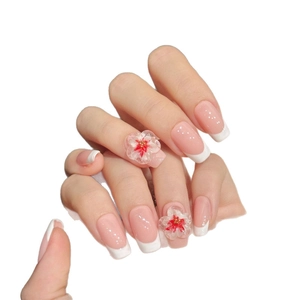 Handmade coffin nails with pink French tips and 3D floral accents for elegant manicure