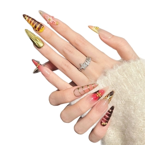 Handmade stiletto press-on nails with amber texture, gold patterns and 3D floral accents