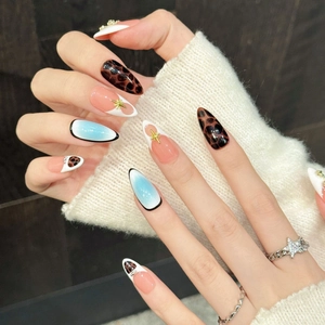 Pink leopard star cross press-on nails with blue gradient and star charms