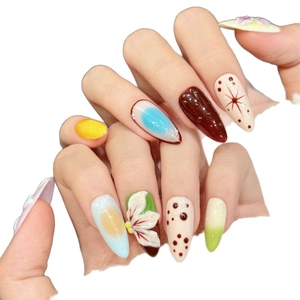 Handmade floral press-on nails with 3D embossed flowers and colorful stiletto design