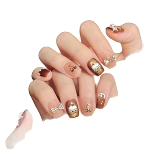 Caramel brown cat-eye press-on nails with 3D cherry, bear and rhinestone bow decor