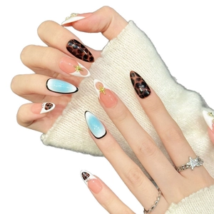 Pink leopard print press-on nails with star charms and crystals in long almond shape