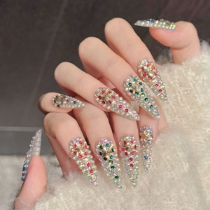 Luxurious long stiletto press-on nails with colorful rhinestones and floral patterns