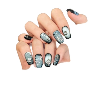 Sparkly dark blue snowflake cat-eye press-on nails with silver rhinestones and pearls