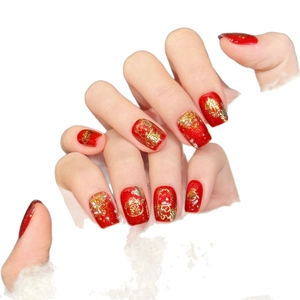 Red and gold Chinese New Year press-on nails with Fu character and zodiac patterns