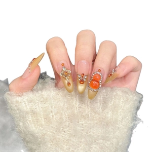 Luxury champagne amber press-on nails with long stiletto shape and 3D rhinestone jewelry
