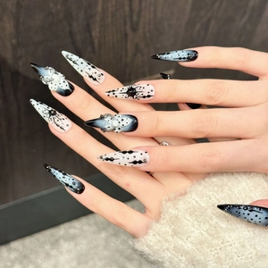 Handmade stiletto press-on nails with dark ink splatter, white flowers and goth star motifs