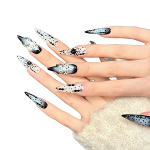 Gothic stiletto press-on nails with dark ink splatter, metal rings and pearls