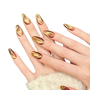 Caramel amber cat eye press-on nails with golden shimmer and white geometric lines