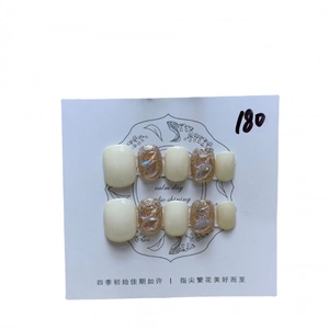 Short round white press-on nails with golden glitter, aurora gemstones and 3D relief