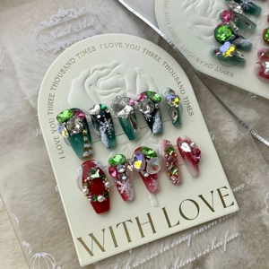Handmade Christmas press-on nails with red, green, pearl and snowflake patterns