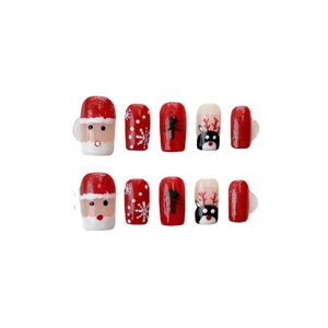 Handmade Christmas press-on nails featuring Santa, reindeer, and snowflakes in festive red