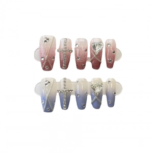 Handmade press-on nails with red blue gradient design featuring metallic cross and chain