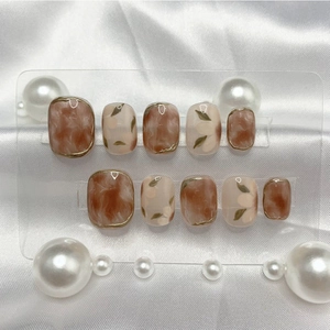 Handmade short round press-on nails with brown marble dye and floral art design