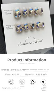 Detail view of handmade press-on nails with blue heart gems and aurora glitter flakes