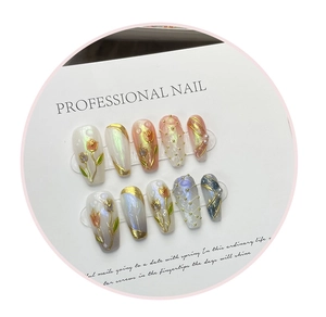 Macro detail of handmade press-on nails featuring 3D tulip floral reliefs and pearl finish