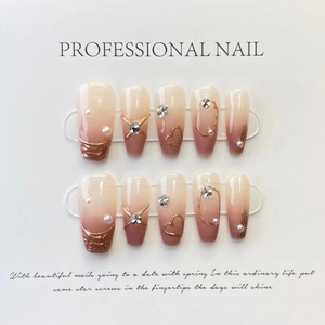 Detail of luxury press-on nails with 3D metal lines, pearls, and rhinestones