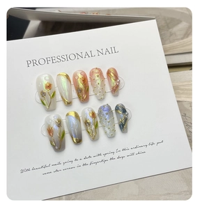 Macro shot of 10pcs handmade press-on nails with 3D tulip flowers and pearl accents
