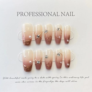 Pink and white gradient press-on nails with pearls, crystals and 3D metallic heart details