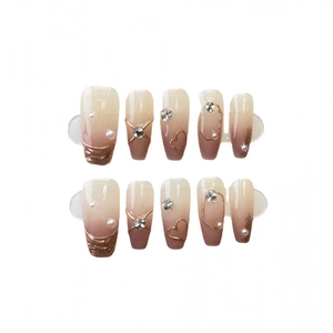 Gradient nude and brown press-on nails with 3D gold hearts and pearl accents