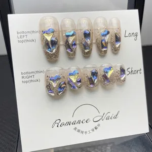Handmade press-on nails with iridescent blue-purple gems and shimmer nude base