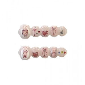 Handmade press-on nails with pink base, strawberry bunny motifs and sparkling crystals