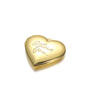 Close-up of heart-shaped gold locket with 'I Love You' engraving and hinge detail