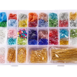 Close-up of 24-grid organizer box filled with colorful glass seed beads and gold findings