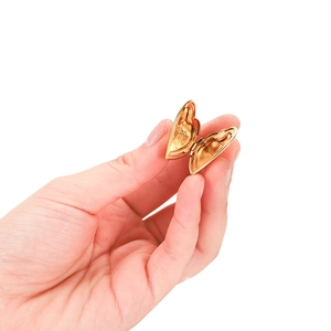 Macro detail of a hand-held small heart-shaped golden locket pendant for photos