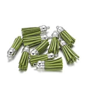Detailed view of grass green velvet tassels with silver metal caps for DIY jewelry making