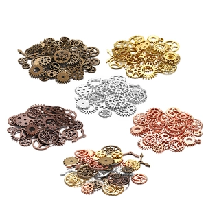Steampunk gear assortment for UV resin DIY crafts in four metallic finishes on white background
