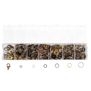 Macro view of multi-color lobster clasps and open jump rings in a 7-slot storage case