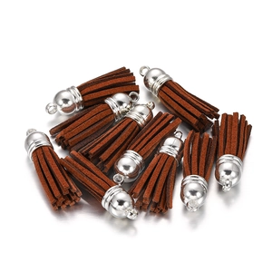 Close-up of dark brown suede tassels with silver metal caps for DIY jewelry crafting