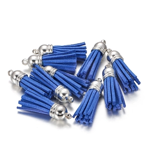 Detail view of royal blue faux suede tassel pendants with polished silver metal caps