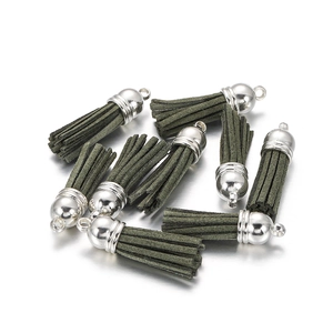 Detail of dark green suede tassels with silver caps for DIY jewelry and earrings
