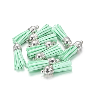 Detail of mint green suede tassels with silver metal caps for DIY jewelry making