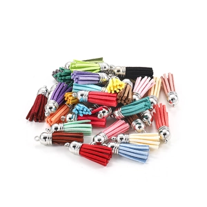 Close-up of colorful velvet tassel pendants with silver metal caps for DIY jewelry