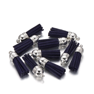 Macro view of dark purple suede tassels with silver metal caps for DIY jewelry making