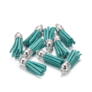 Detail of turquoise faux suede tassel charms with silver metal caps for DIY jewelry