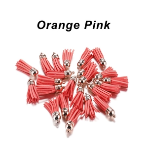 Detail of orange pink velvet tassels with rose gold caps for DIY jewelry making