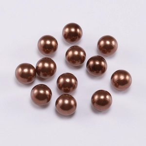 Macro view of 12 glossy bronze ABS faux pearls for DIY jewelry making accessories