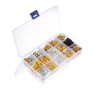 Macro view of clear storage box with golden and silver dreadlock beads and hair charms
